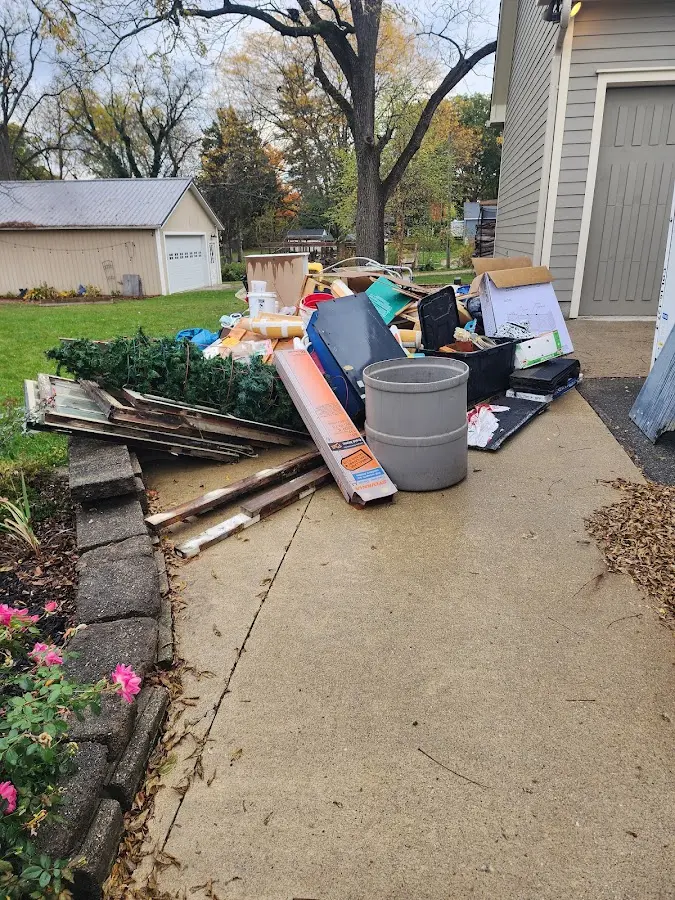 Dumpster being loaded with debris for Estate Cleanout Dumpster Rental in Pleasant View